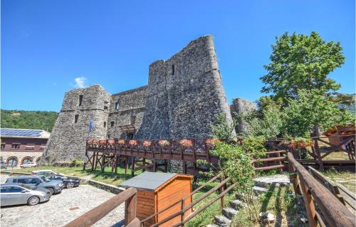 a castle with a bench in front of it at Nice Apartment In Santo Stefano D'aveto in Santo Stefano dʼAveto