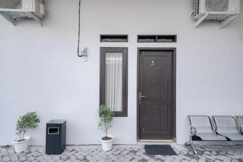 a door and a bench in front of a building at RedDoorz @ Jalan Urip Sumoharjo Lampung in Kedaton