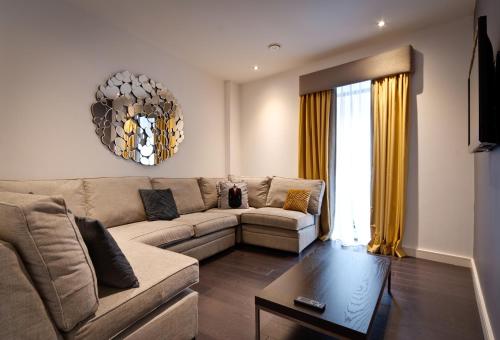 a living room with a couch and a table at EPIC Apart Hotel - Seel Street in Liverpool
