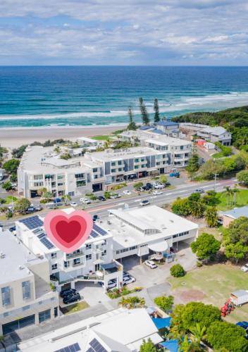 an aerial view of a building with a heart on it at Caba Break Holiday Apartments in Cabarita Beach