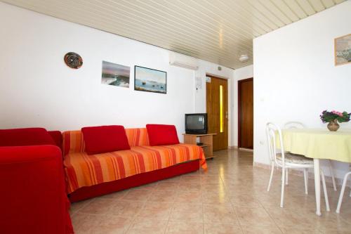a living room with a couch and a table at Apartments by the sea Milna, Vis - 2461 in Rukavac