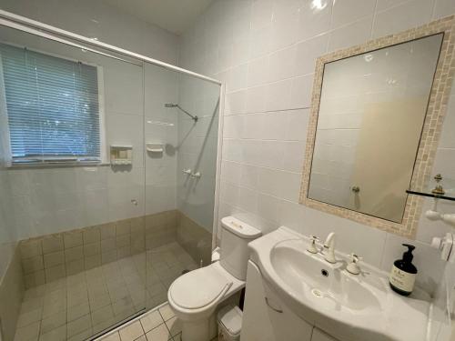 a bathroom with a toilet and a sink and a shower at Elizabeth Beach Guest House in Elizabeth Beach