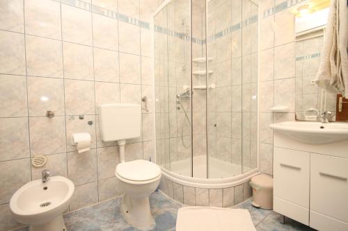 a bathroom with a toilet and a shower and a sink at Apartment Mali Losinj 2486a in Mali Lošinj