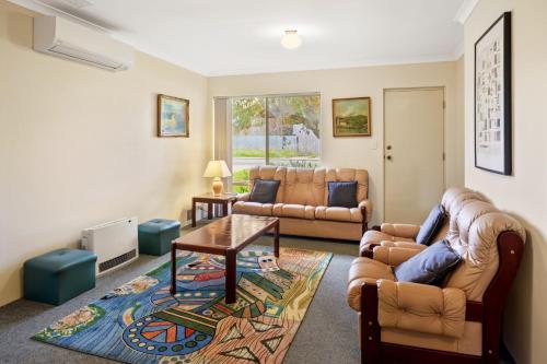 a living room with a couch and a table at Prowse Pad in Dunsborough