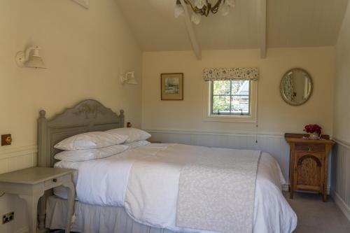 a bedroom with a white bed and a window at Aldourie Lodge - Lake Tekapo in Lake Tekapo