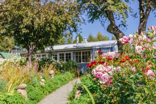 a garden with flowers in front of a building at Aldourie Lodge in Lake Tekapo