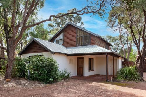 a house with a gambrel roof with a garage at Shady Shack in Dunsborough