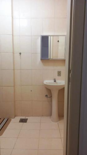 a small bathroom with a sink and a mirror at Rent apartament Rio de Janeiro Copacabana in Rio de Janeiro
