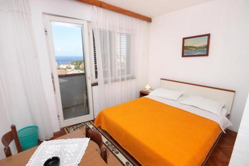 a bedroom with a bed and a large window at Apartments with a parking space Mali Losinj (Losinj) - 2507 in Mali Lošinj