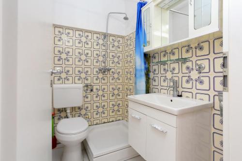 a bathroom with a white toilet and a sink at Apartments by the sea Drasnice, Makarska - 2644 in Drasnice