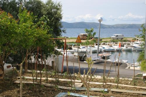 a marina with boats parked in the water at Apartments by the sea Igrane, Makarska - 2679 in Igrane