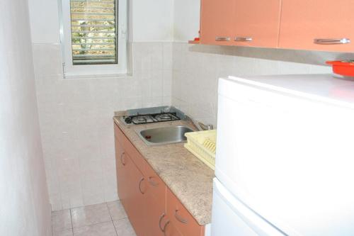 a small kitchen with a sink and a counter at Apartments and rooms by the sea Zaostrog, Makarska - 2662 in Zaostrog