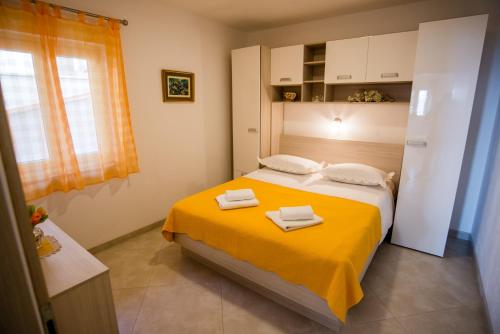 a bedroom with a bed with two towels on it at Apartments by the sea Promajna, Makarska - 2605 in Promajna