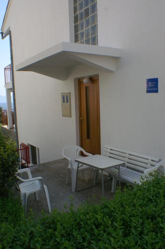 a patio with a table and chairs and a building at Apartments by the sea Podaca, Makarska - 2635 in Podaca