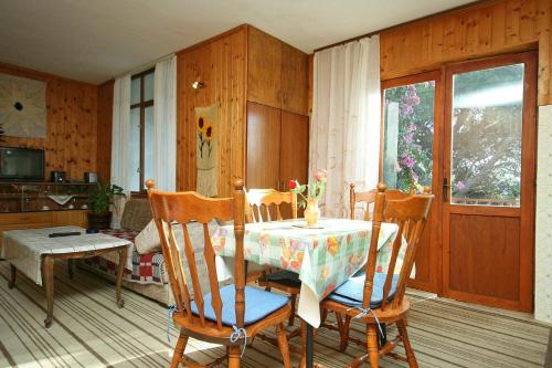 a dining room with a table and four chairs at Apartments by the sea Zivogosce - Mala Duba, Makarska - 2603 in Igrane