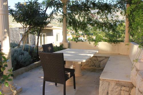 a white table and chairs on a patio at Apartments and rooms by the sea Slano, Dubrovnik - 2681 in Slano