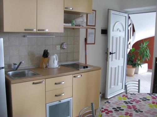 a small kitchen with a sink and a door at Apartment Zaostrog 2625a in Zaostrog