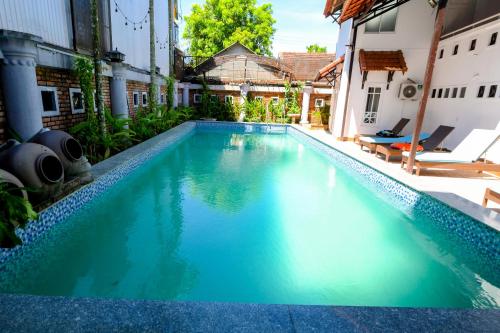 a large swimming pool in the middle of a building at Golden Star Villa Hue in Hue