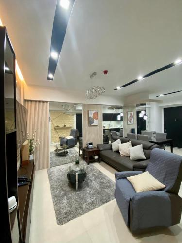 a living room with a couch and a table at Aeon Towers Executive Suite 2BR 18th floor in Davao City