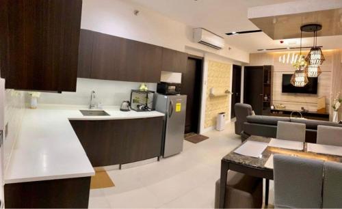 a kitchen and living room with a counter and a kitchen at Aeon Towers Executive Suite 2BR 18th floor in Davao City