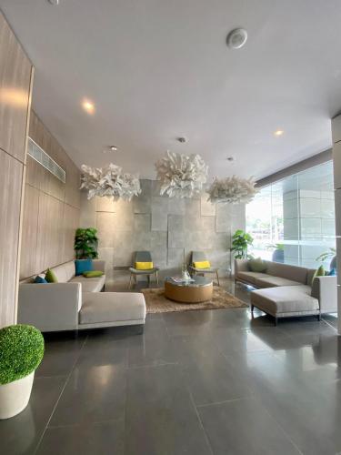 a large living room with couches and tables at Aeon Towers Executive Suite 2BR 18th floor in Davao City