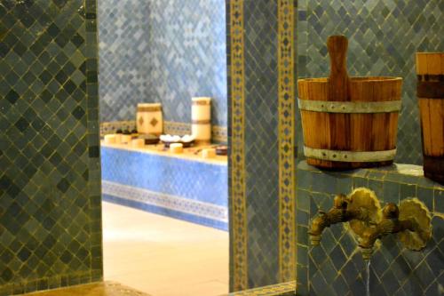 a bathroom with a tub, sink, and tiled floor at Casablanca Le Lido Thalasso & Spa (ex Riad Salam) in Casablanca
