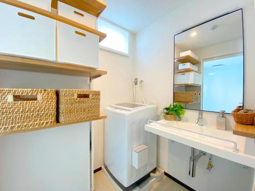 a bathroom with a sink and a mirror at Joka Base in Kakegawa