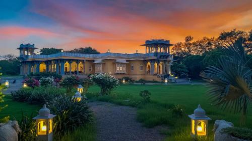 a large house with lights in the yard at Dev Shree Deogarh in Devgarh