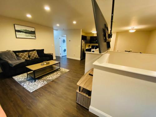 a living room with a couch and a table at Beautiful 2 bedroom 1 bath apartment with private garage in Anchorage