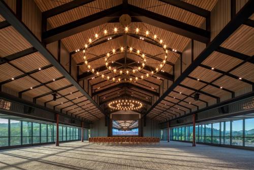 a rendering of the inside of a barn with a chandelier at Ramada Plaza by Wyndham Chao Fah Phuket in Phuket Town