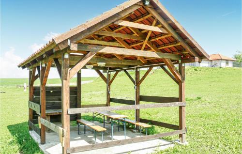 a pavilion with benches and tables in a field at Nice Studio In Borcz With Kitchen in Borcz