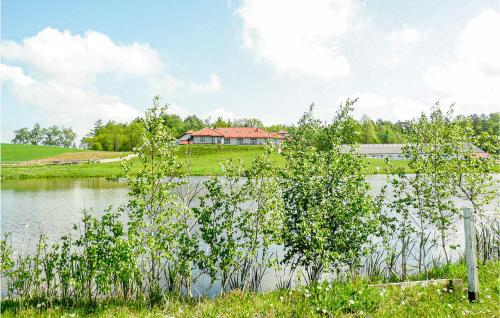 a house on a hill next to a lake at Nice Studio In Borcz With Kitchen in Borcz