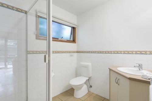 a bathroom with a toilet and a sink at Split Point Cottages in Aireys Inlet