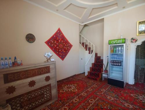 a room with a drink vending machine and a staircase at XIVA AZIM OTA in Khiva