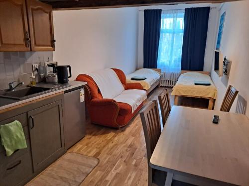 a kitchen with a couch and a table in a room at Apartament Obrońców Pokoju 6 in Opatów