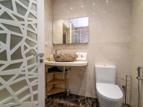 a bathroom with a toilet and a sink and a mirror at VACATION MARBELLA I Oasis on the Coast, Top Location, Ultra Modern Building in Marbella