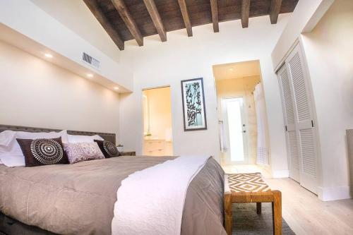 a bedroom with a large bed and two windows at Villa at St. James Place “H”, Luxury, Pet Friendly in Miami