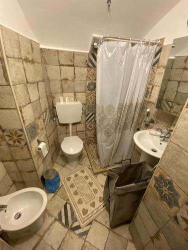 a bathroom with a toilet and a sink and a shower at Casa Turnone in Martina Franca
