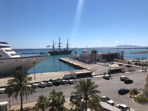 a cruise ship docked in a harbor with a parking lot at Drepanon, prospettive sul mediterraneo B&B in Trapani