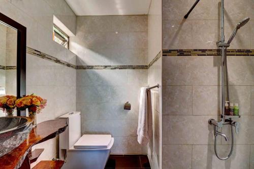 a bathroom with a shower and a toilet and a sink at Tahiti beach house in Arue