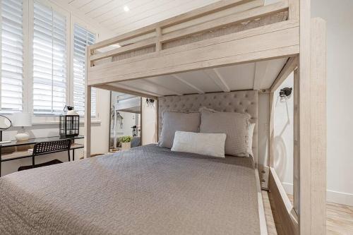 a bedroom with a canopy bed with a desk at Designer Cozy Ski in and out in Whistler