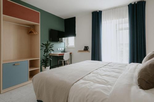 a bedroom with a white bed and a table at Townhouse17 Boutique Bed & Breakfast in Victoria