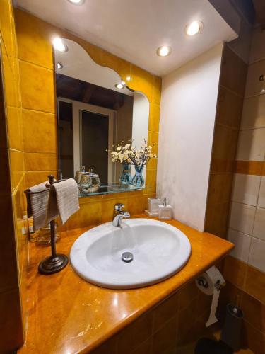 a bathroom with a sink and a mirror at Semelia's Guest house in Spáta