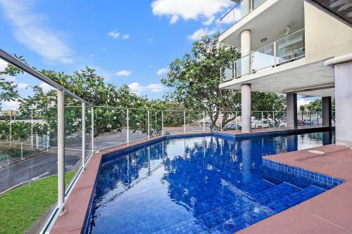 a swimming pool in front of a house at Alta Vista - City View Oasis in the Heart of Darwin in Darwin