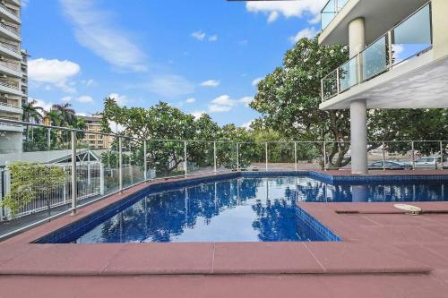 a swimming pool in front of a building at Alta Vista - City View Oasis in the Heart of Darwin in Darwin