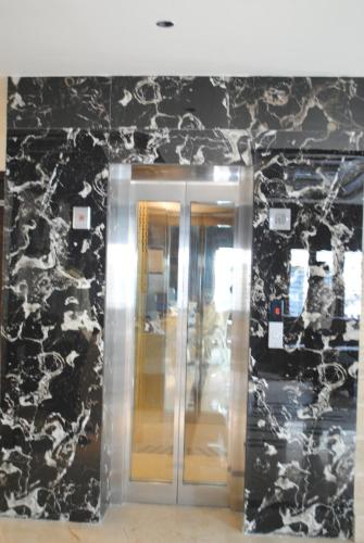 a elevator in a building with a black and white wall at Mysore Royale in Mysore