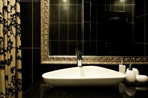 a white sink in a bathroom with a mirror at Villa Monticello Boutique Hotel in Accra