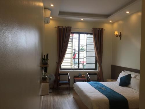 a hotel room with a bed and a window at Noi Bai Boutique Hotel in Hanoi