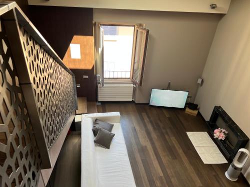 a living room with a couch and a window at Casa Cavour Lecco - Downtown Design Penthouse in Lecco