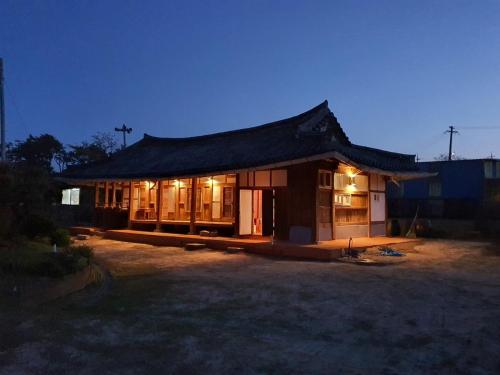 a small house with a roof with lights at Big Blue House in Boseong